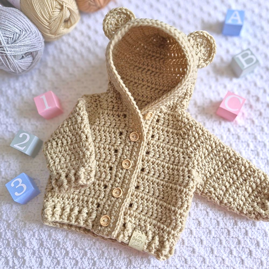 Handmade Crochet Baby Hooded Cardigan – Newborn to 12 Months – Baby Toddler Cardigans crafted in soft acrylic yarn and available in multiple colours by Twisted by the Sea.