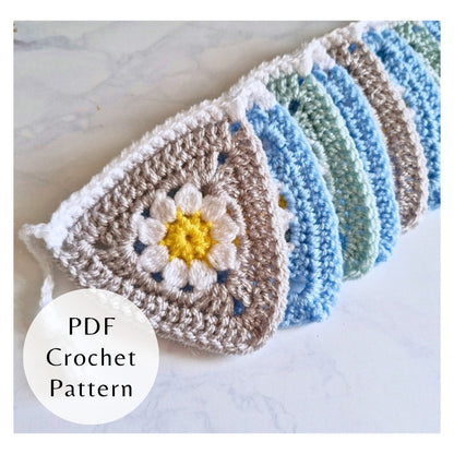 Crocheted bunting with floral design on a light background, featuring a PDF crochet pattern label.
