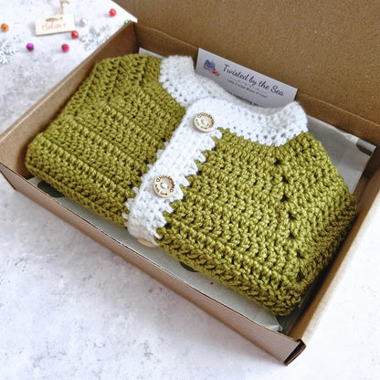 Santa themed crochet baby cardigan boxed in mistletoe green and white